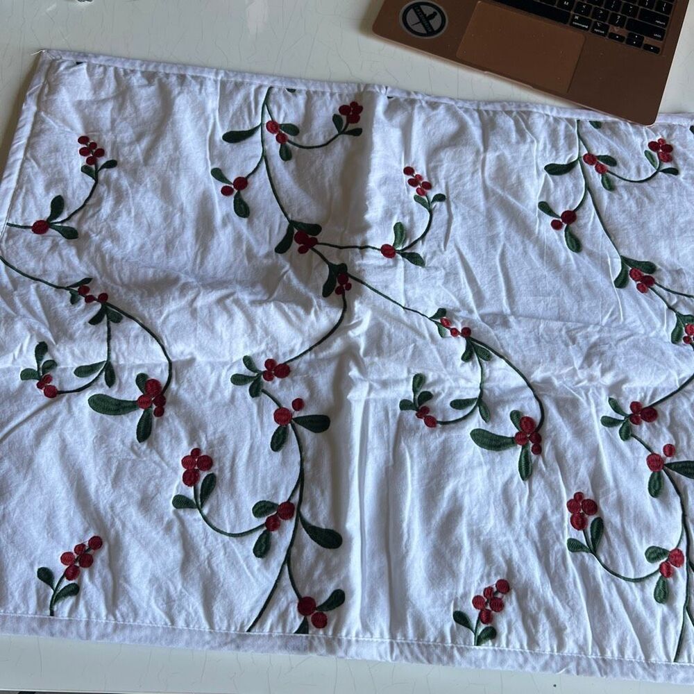 St. Nicholas Square Christmas pillow cases featuring embroidered trailing green